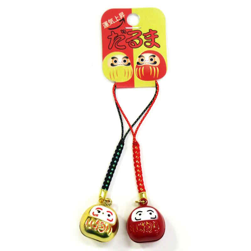 Deux porte-clés Daruma traditionnels japonais, un doré et un rouge.