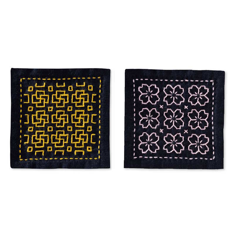 Deux sous-verres en tissu bleu marine avec broderies japonaises jaunes et roses